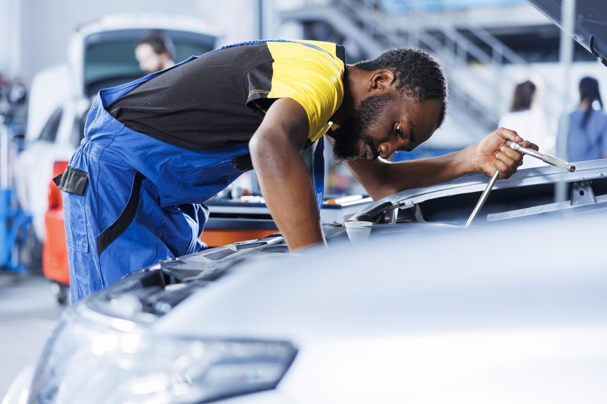 Specialist fixes car ignition in garage
